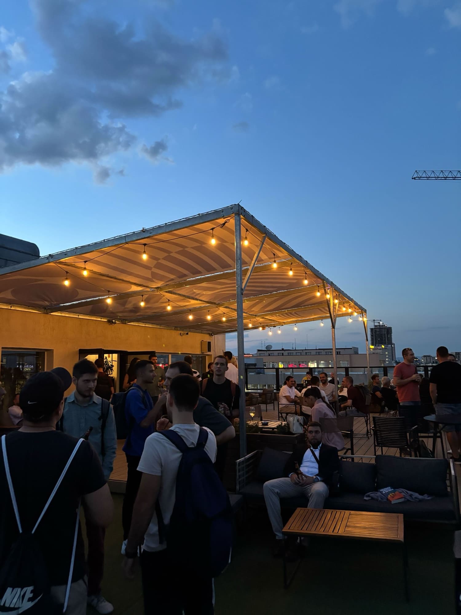 The lit canopy on the Barter rooftop at blue hour