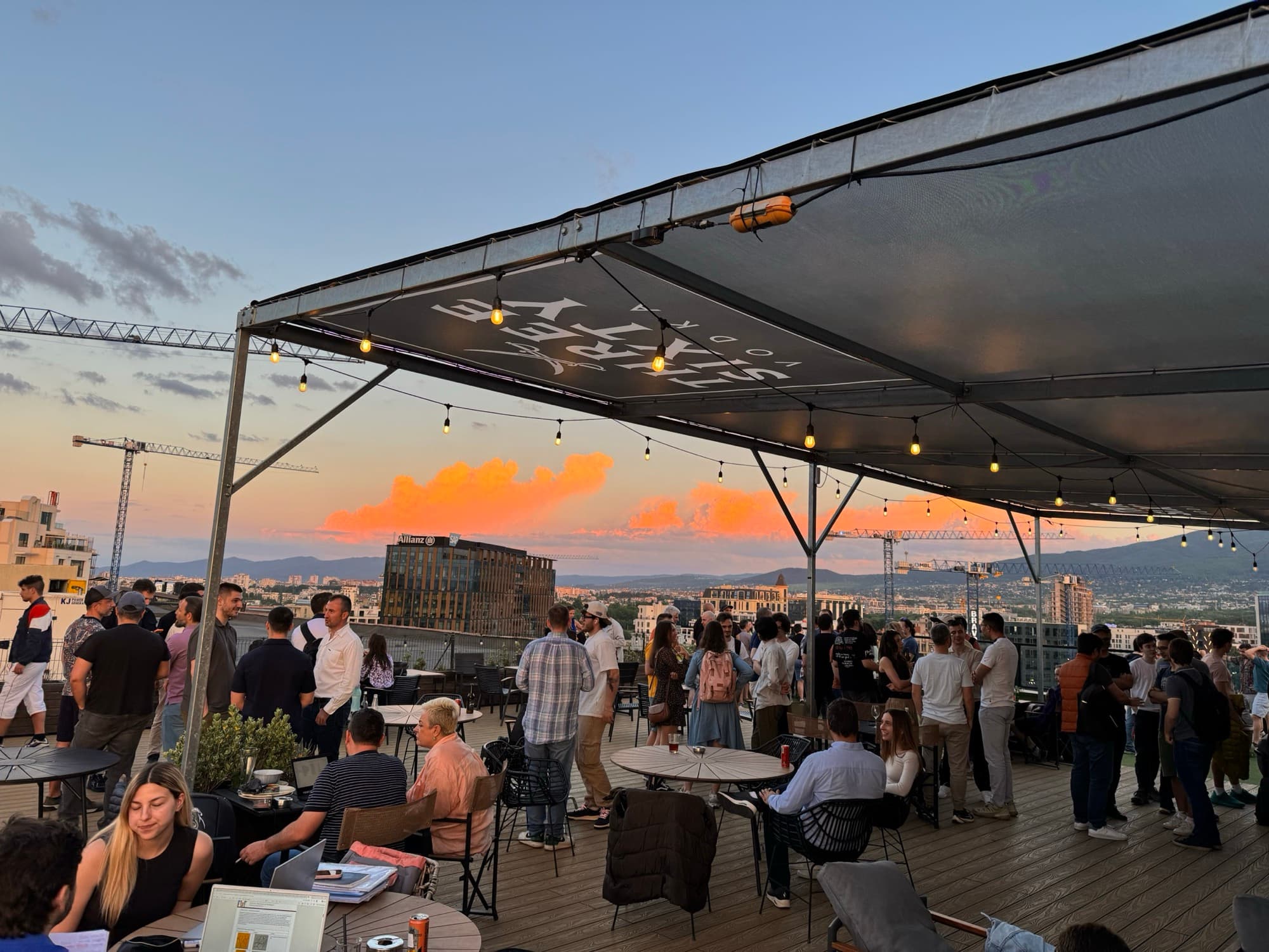 The Barter rooftop at sunset, full of people